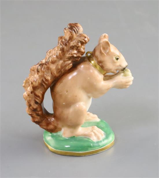A Rockingham porcelain figure of a seated squirrel, c.1830, H. 7.8cm, splinter chip to one ear